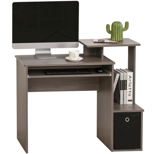 Computer desk with a monitor, keyboard, and books on a white background